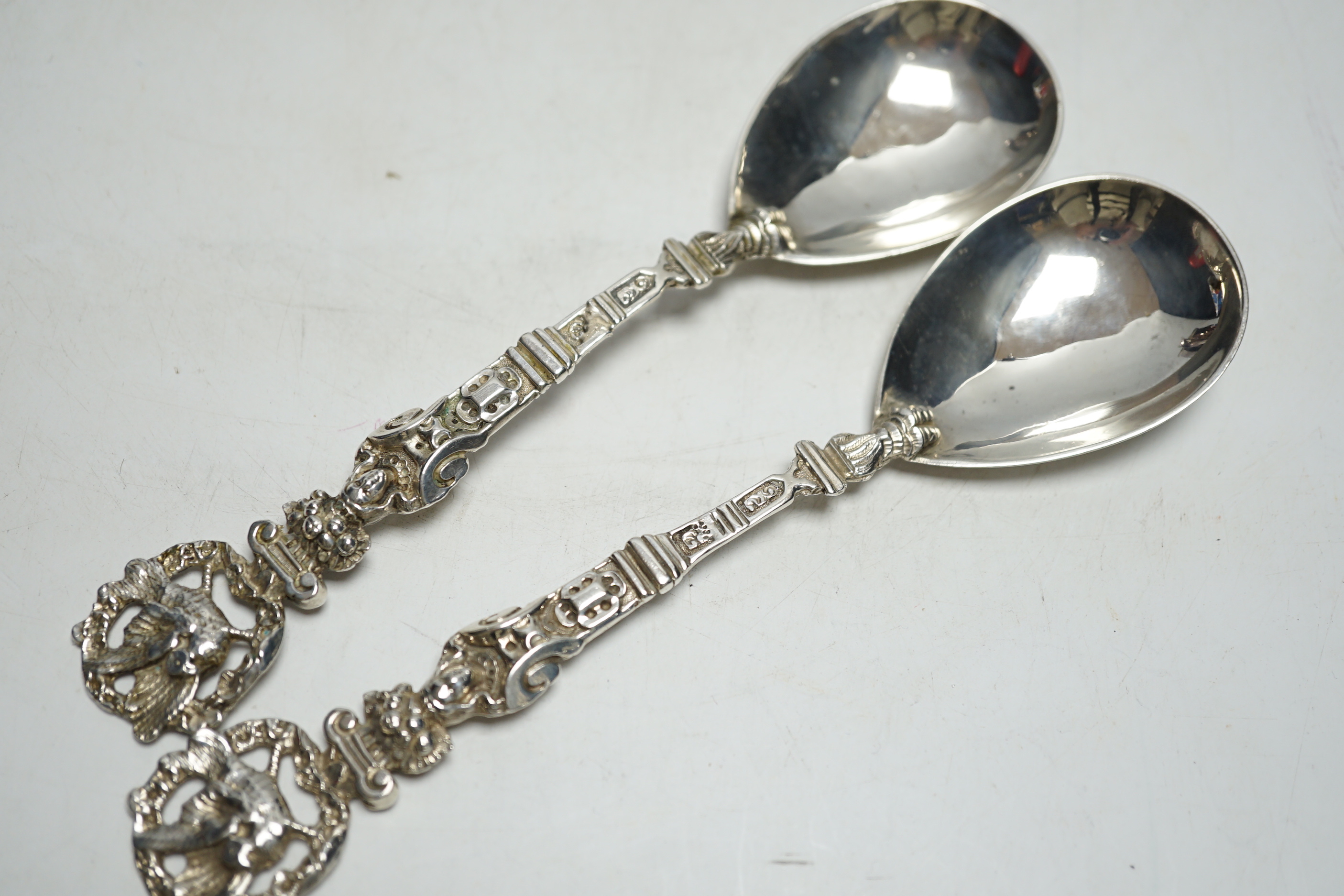 A pair of Victorian silver serving spoons, with figural handles and phoenix terminals, Charles Boyton, London, 1882, 18.9cm, 4.2oz.